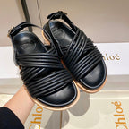 CHLOÉ CROSS STRAP SANDAL IN BLACK RUBBER WITH GOLD HARDWARE