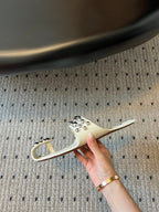 ALAIA FOLDED FLAT MULES WITH SPHERES ON WHITE CALFSKIN