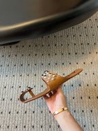 ALAIA FOLDED FLAT MULES WITH SPHERES ON COPPER BROWN CALFSKIN
