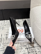 POINTED HIGH PUMPS IN BLACK PATENT CALFSKIN WITH CRYSTAL BUCKLE