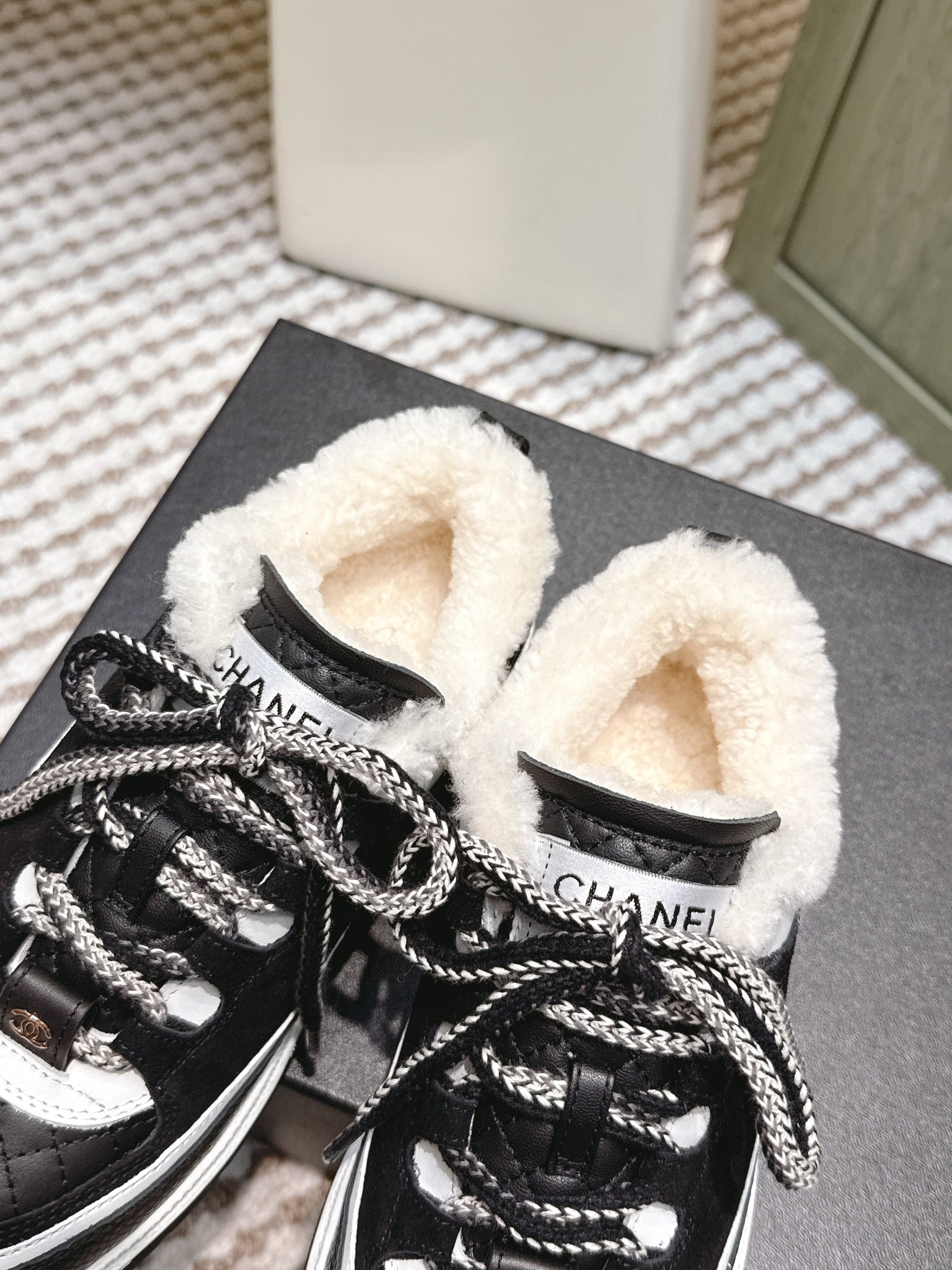 Chanel 26s Thick-Sole Sneakers In Black And White Calfskin With Fur Lining