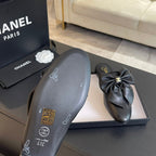BIG BOW FLAT MULE SANDALS IN BLACK LAMBSKIN