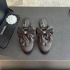 BIG BOW FLAT MULE SANDALS IN BLACK SILK