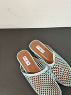 ALAIA FLAT MULES IN LIGHT BLUE MESH FISHNET