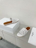 ALAIA VIENNE FLAT MULES IN WHITE LAMBSKIN