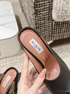 ALAIA SPIKE JEWEL MULES IN BLACK CALFSKIN