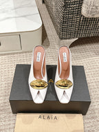 ALAIA SPIKE JEWEL MULES IN WHITE CALFSKIN WITH GOLD HARDWARE