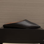 ALAIA FLAT MULE IN BLACK LAMBSKIN